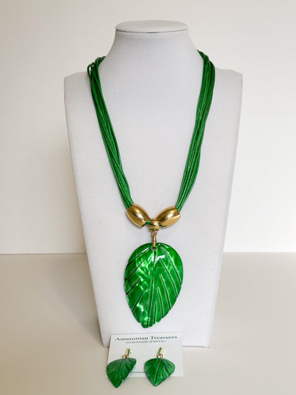 Amazonian Treasures green mother of pearl leaf necklace and earring set with gold-tone accents on a display bust.