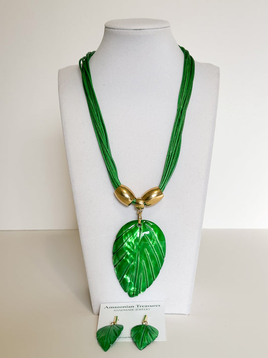 Amazonian Treasures green mother of pearl leaf necklace and earring set with gold-tone accents on a display bust.