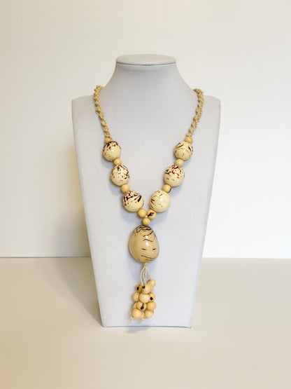 Amazonian Treasures statement necklace featuring smooth jarina seeds and tucum fiber on a white display bust.