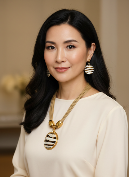 Amazonian Treasures mother of pearl necklace and earring set with gold-tone accents worn by a woman in a cream top.