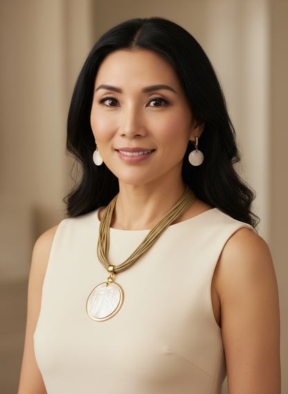 Amazonian Treasures necklace and earring set featuring ivory freshwater mother of pearl with gold-tone accents on a model