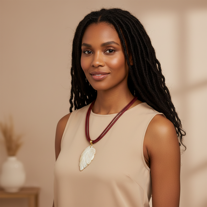 Amazonian Treasures mother of pearl leaf pendant necklace on a woman wearing a beige top