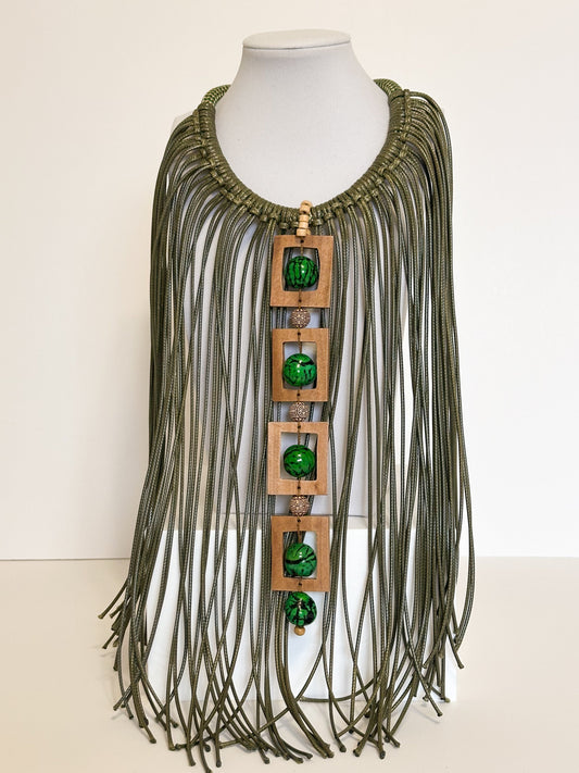 Amazonian Treasures Walking Roots necklace with green paxiúba seeds, natural wood frames, and cascading cotton strands.