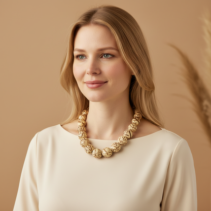 Amazonian Treasures handmade paxiúba seed necklace worn by a woman with blonde hair against a neutral background.