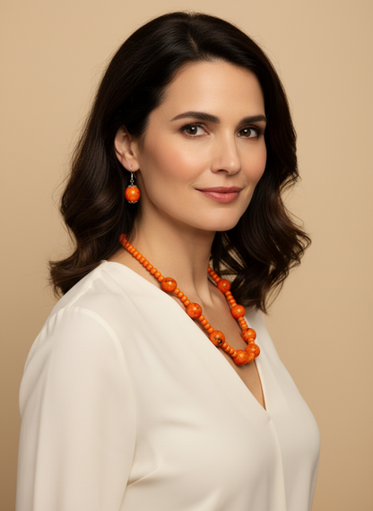 Amazonian Treasures Forest Harmony set featuring orange paxiubinha seed necklace and matching earrings on a woman
