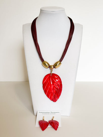 Amazonian Treasures leaf necklace and earring set featuring red mother of pearl pendants with gold-tone accents.