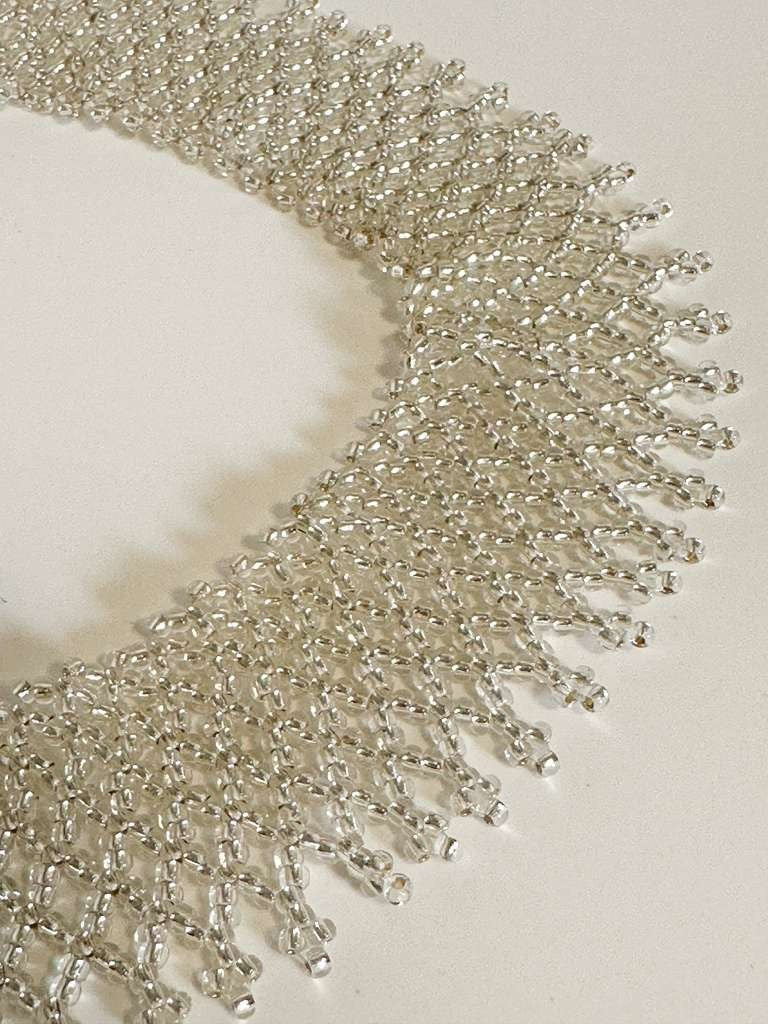Amazonian Treasures Borari Indigenous handcrafted silver glass bead collar necklace with delicate net fringe detail.
