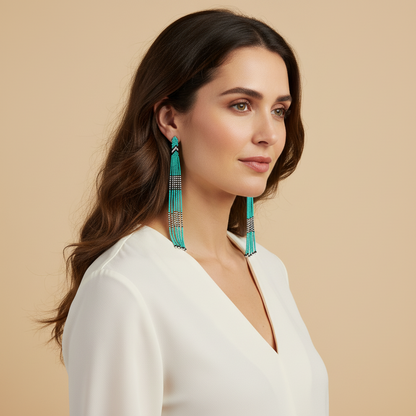 Amazonian Treasures Wai Wai turquoise recycled glass bead drop earrings worn by a woman in a white blouse.