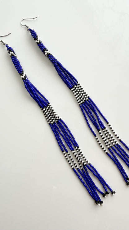 Close-up of blue, white, and black recycled glass beadwork on 6.6 inch earrings