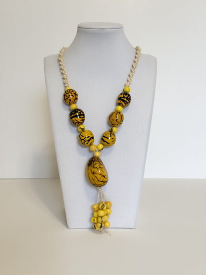 Amazonian Treasures statement necklace featuring yellow jarina beads with black patterns and natural tucum fiber cord.