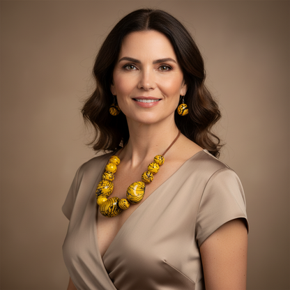Amazonian Treasures yellow tagua seed necklace and matching earrings worn by a woman on a neutral background.