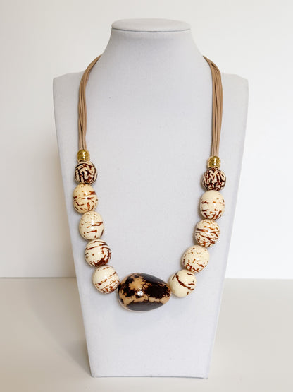 Handmade Amazon necklace made with natural jarina (vegetable ivory) and paxiúba seeds crafted by an artisan from the Amazon forest