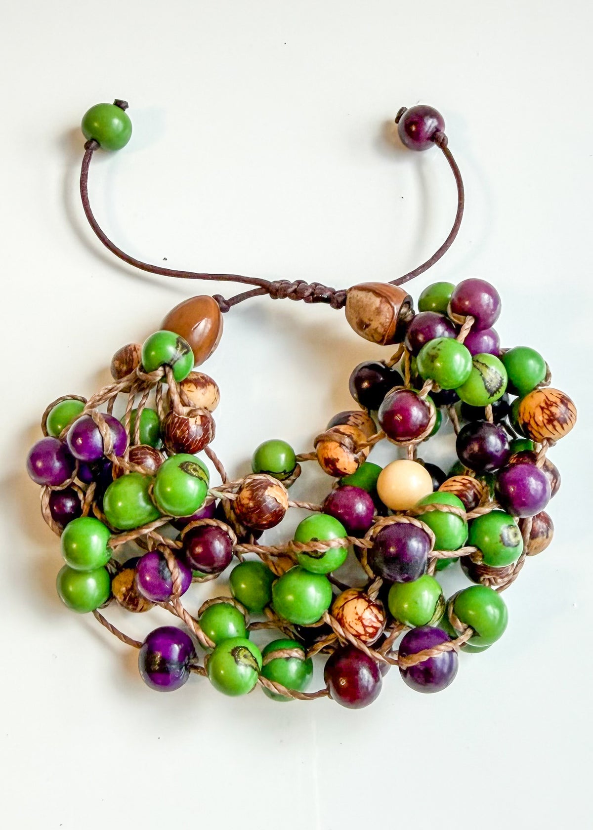 Handcrafted Brazilian Açaí seed bracelet with green purple and natural tones