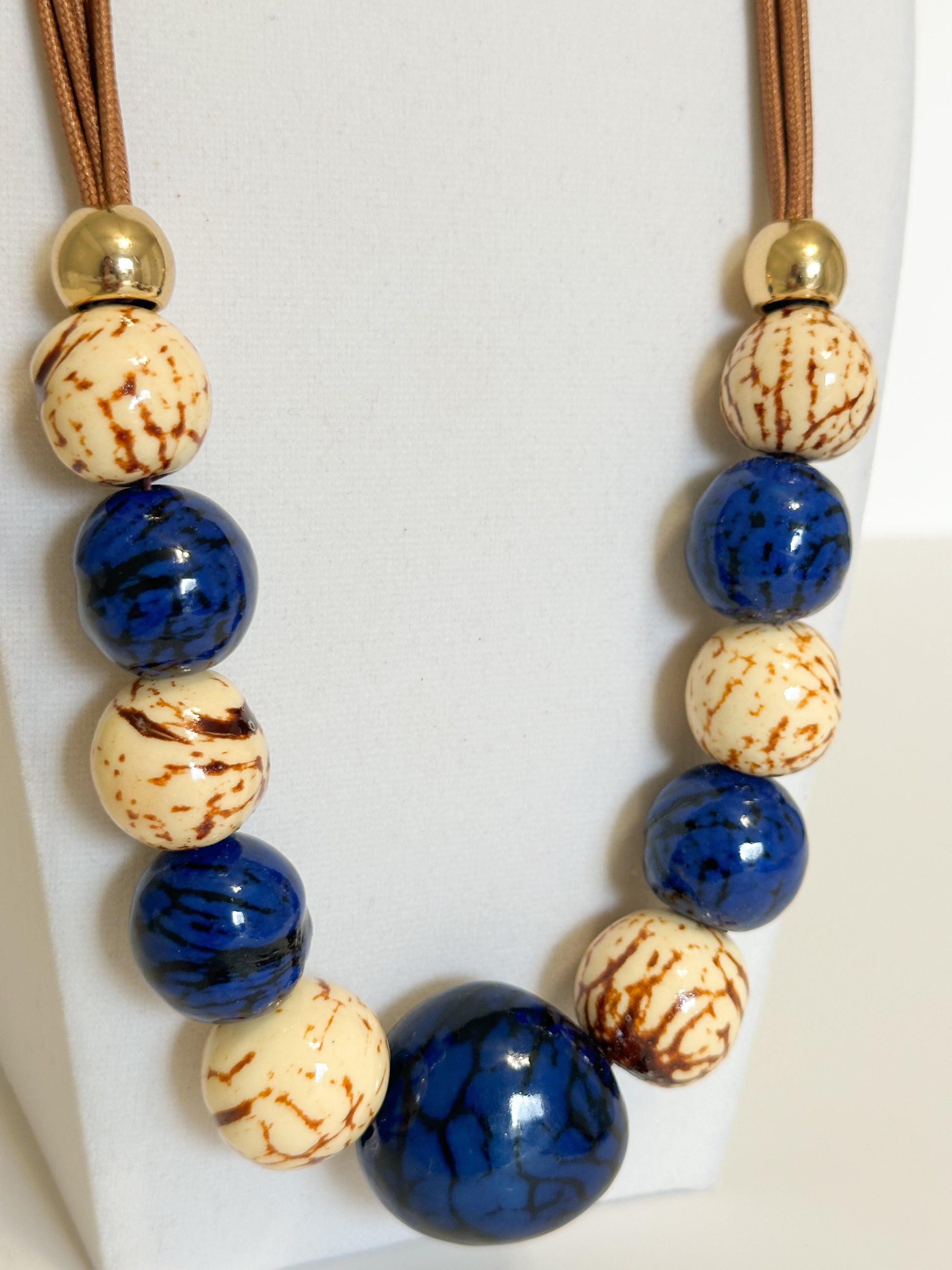 Blue and cream jarina vegetable ivory and paxiúba seed necklace handmade in the Amazon rainforest close up