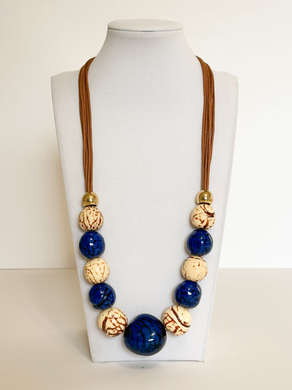 Blue and cream jarina vegetable ivory and paxiúba seed necklace handmade in the Amazon rainforest.
