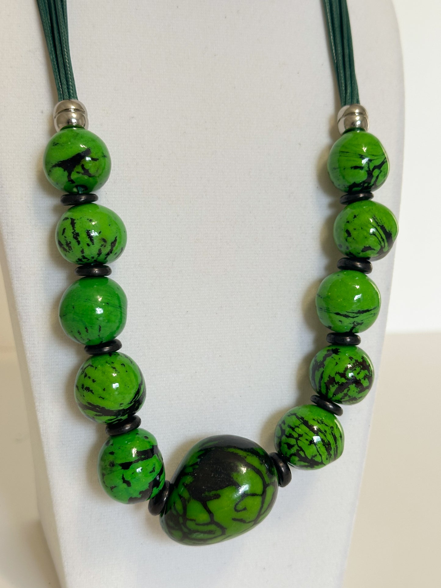 Green jarina and paxiúba seed necklace handcrafted with natural Amazon seeds close-up