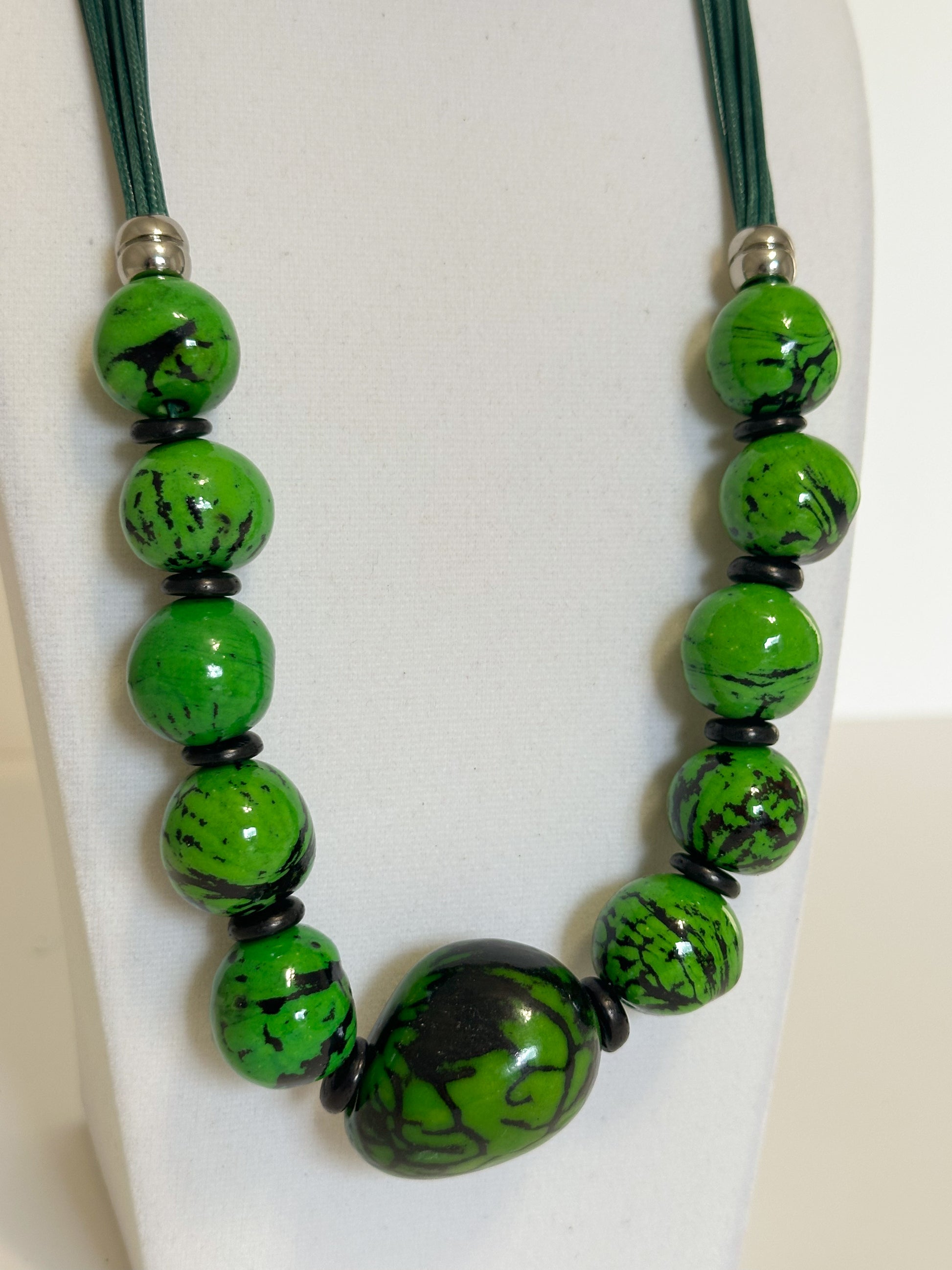 Green jarina and paxiúba seed necklace handcrafted with natural Amazon seeds close-up