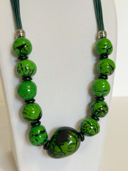 Green jarina and paxiúba seed necklace handcrafted with natural Amazon seeds close-up
