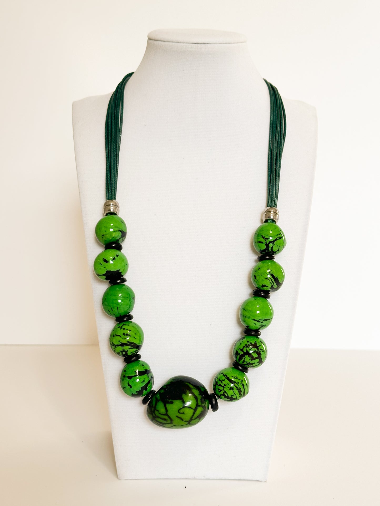 Green jarina and paxiúba seed necklace handcrafted with natural Amazon seeds.