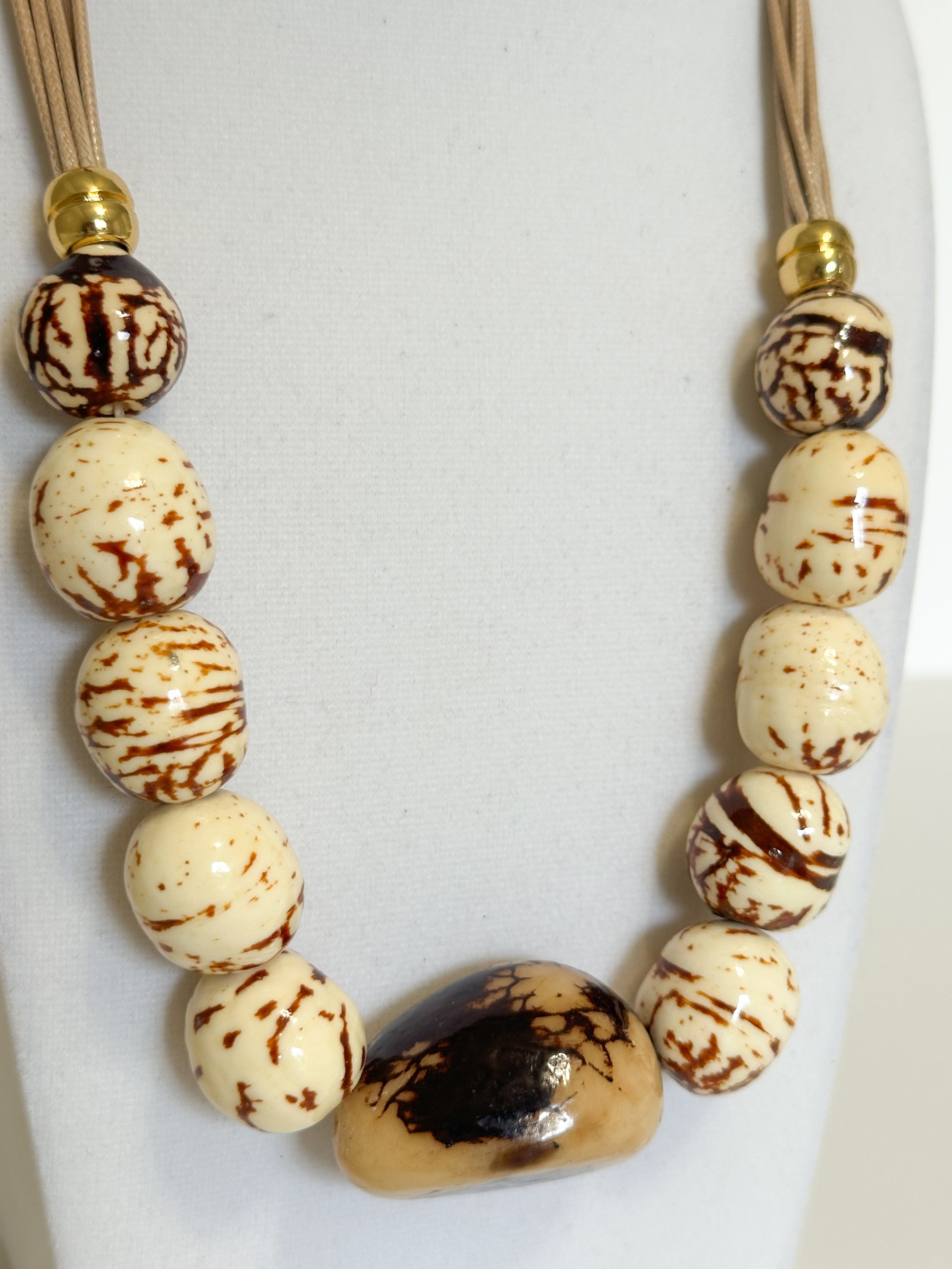 Handmade Amazon necklace made with natural jarina (vegetable ivory) and paxiúba seeds crafted by an artisan from the Amazon forest close up
