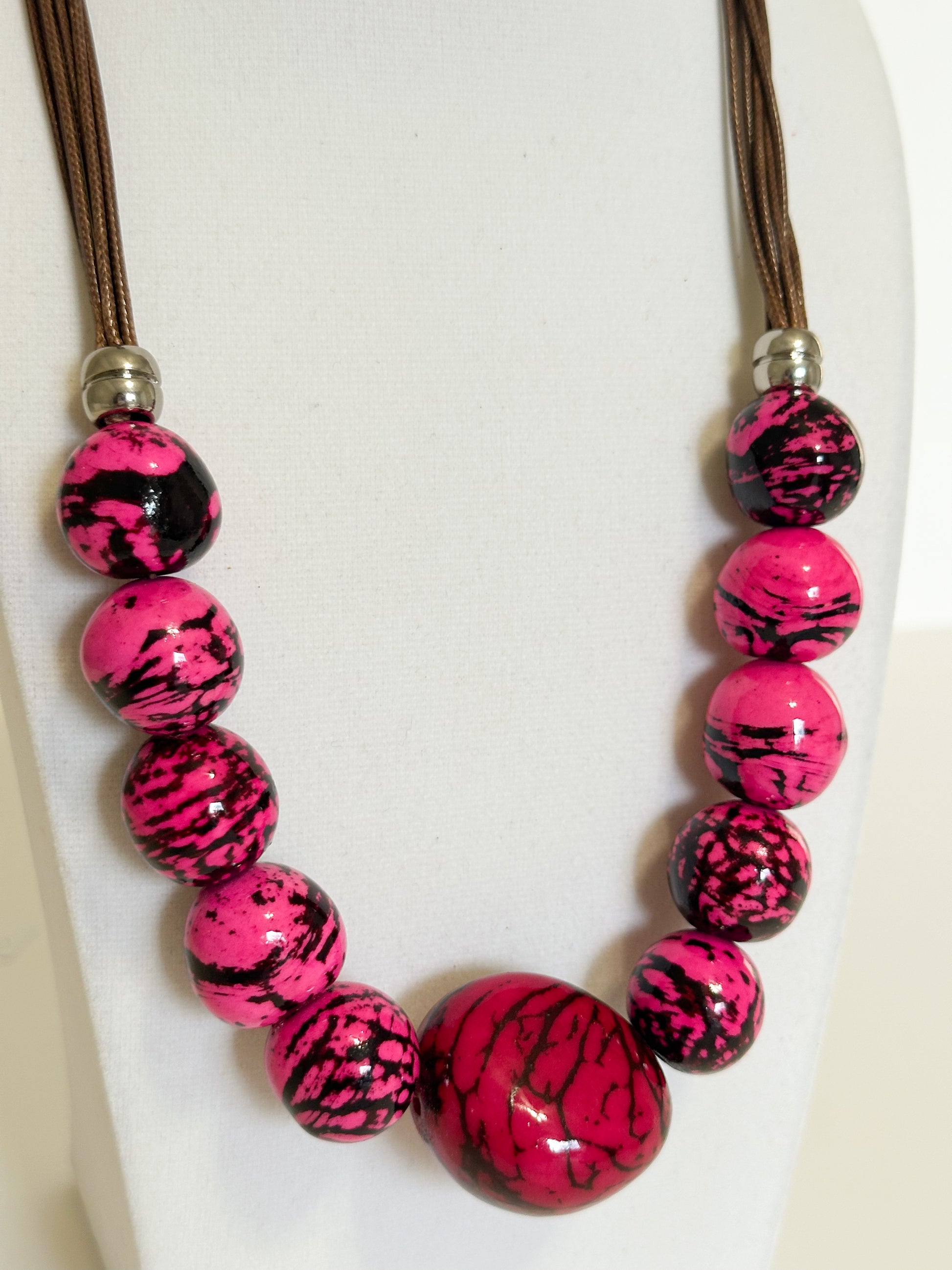 Pink jarina vegetable ivory and paxiúba seed necklace handmade by an Amazon artisan close-up