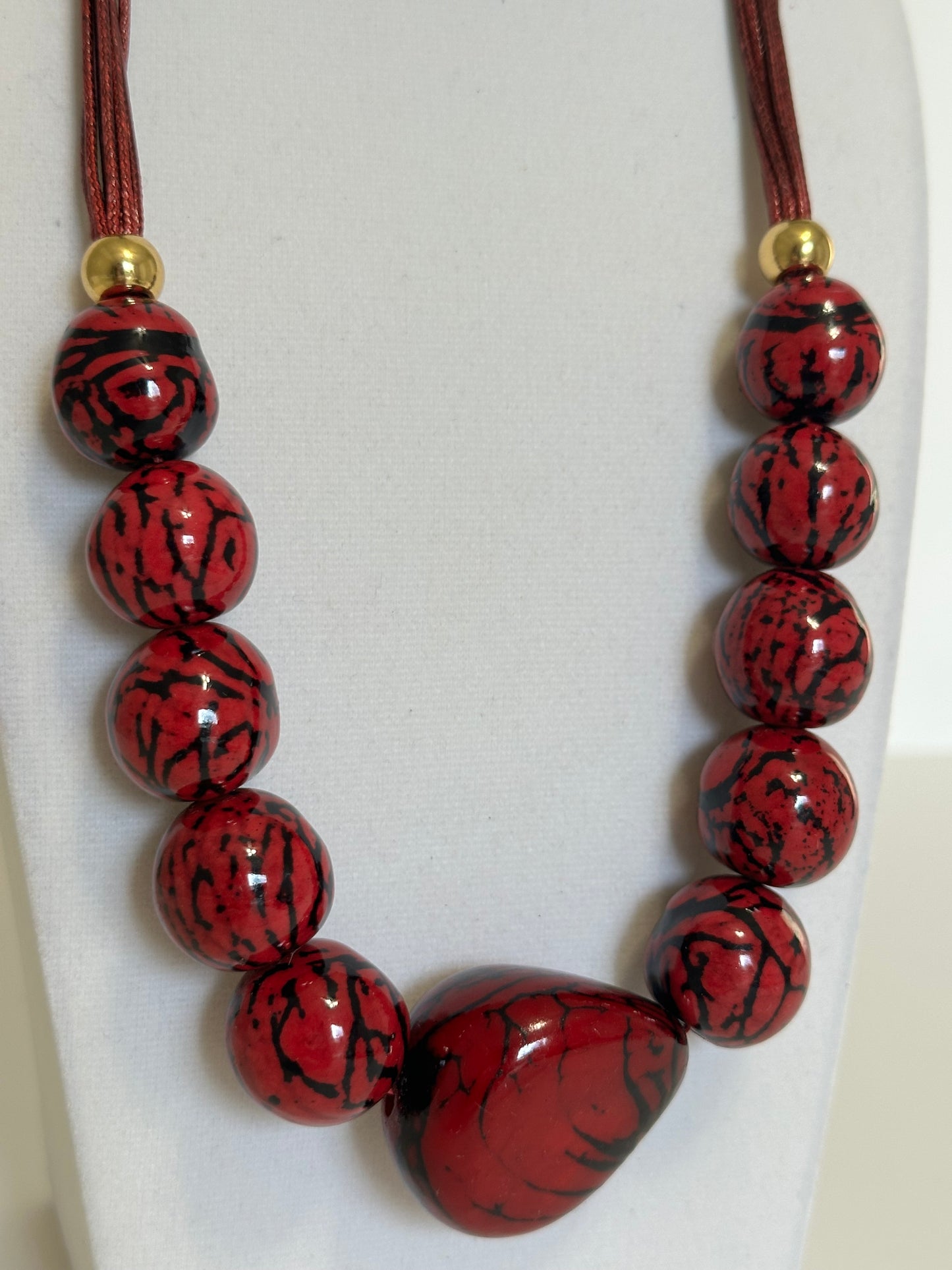 Red jarina and paxiúba seed necklace handcrafted by an Amazon artisan with natural vegetable ivory beads.