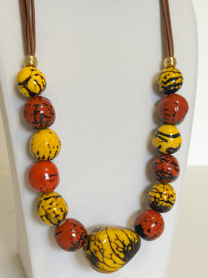 Yellow and red jarina and paxiúba seed necklace handcrafted with natural Amazon seeds close-up
