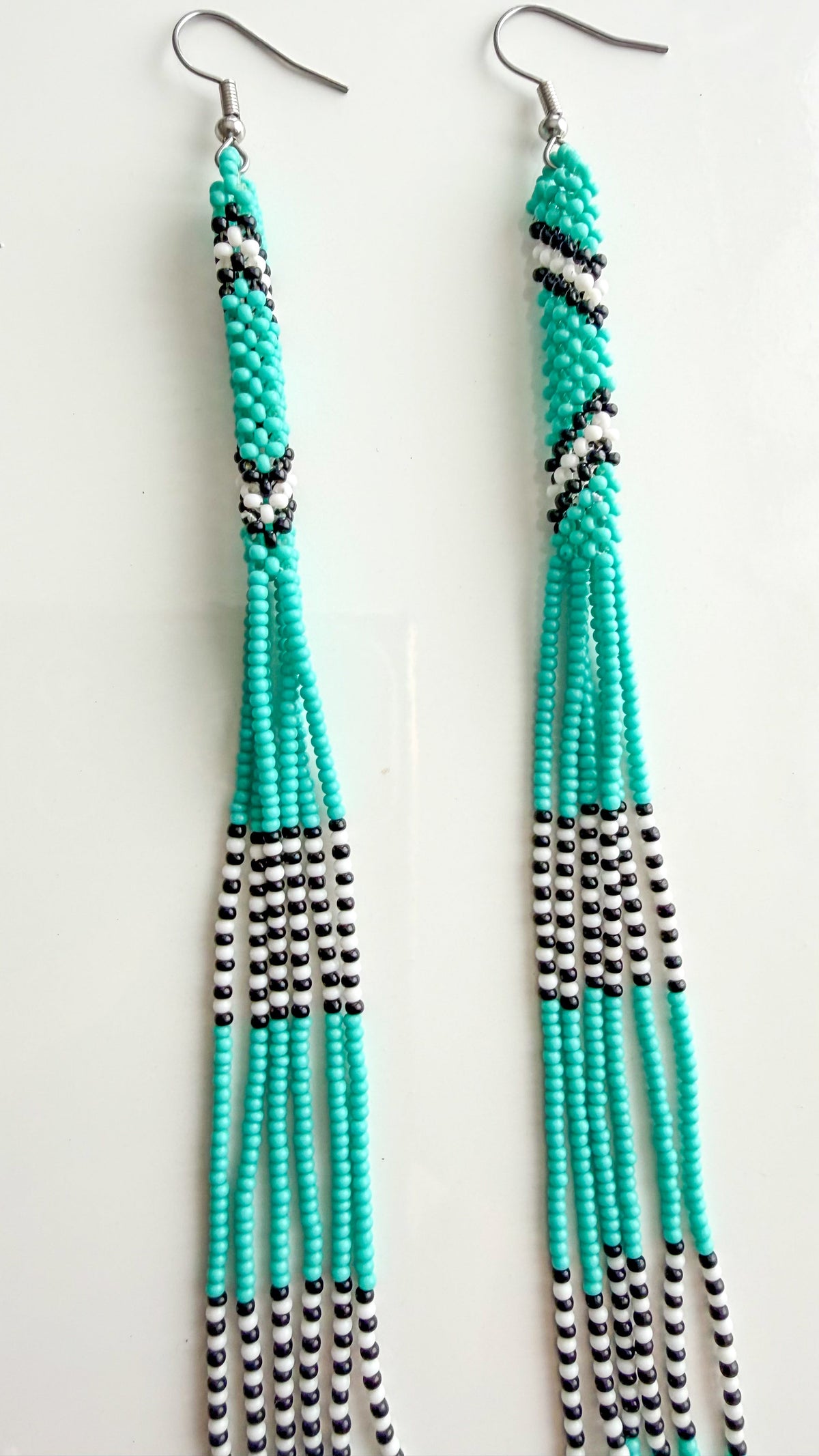 Close-up of turquoise recycled glass beadwork on 6.5 inch earrings