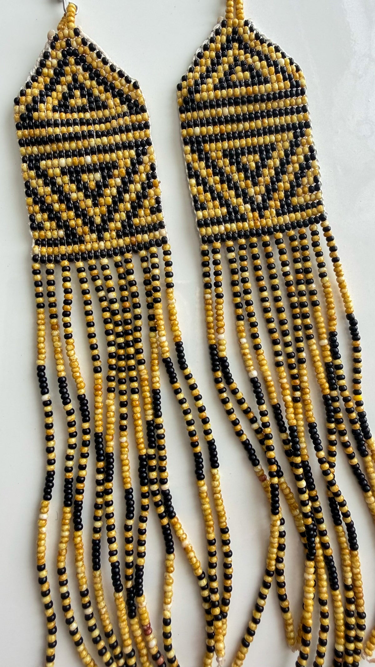 Close-up of Wai Wai beadwork and fringe detail on 5.5 inch earrings